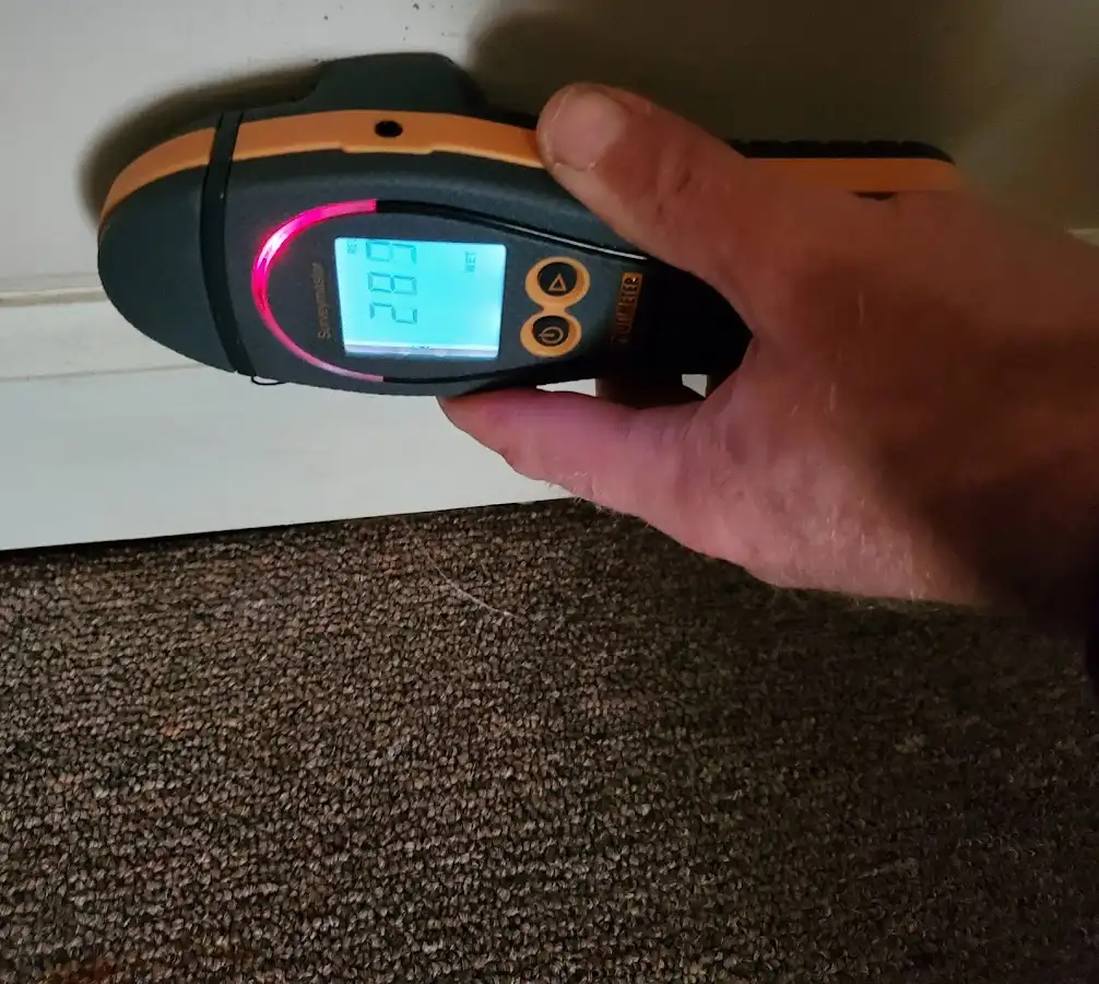 Moisture detection at baseboard during Storm Damage Restoration in Xenia
